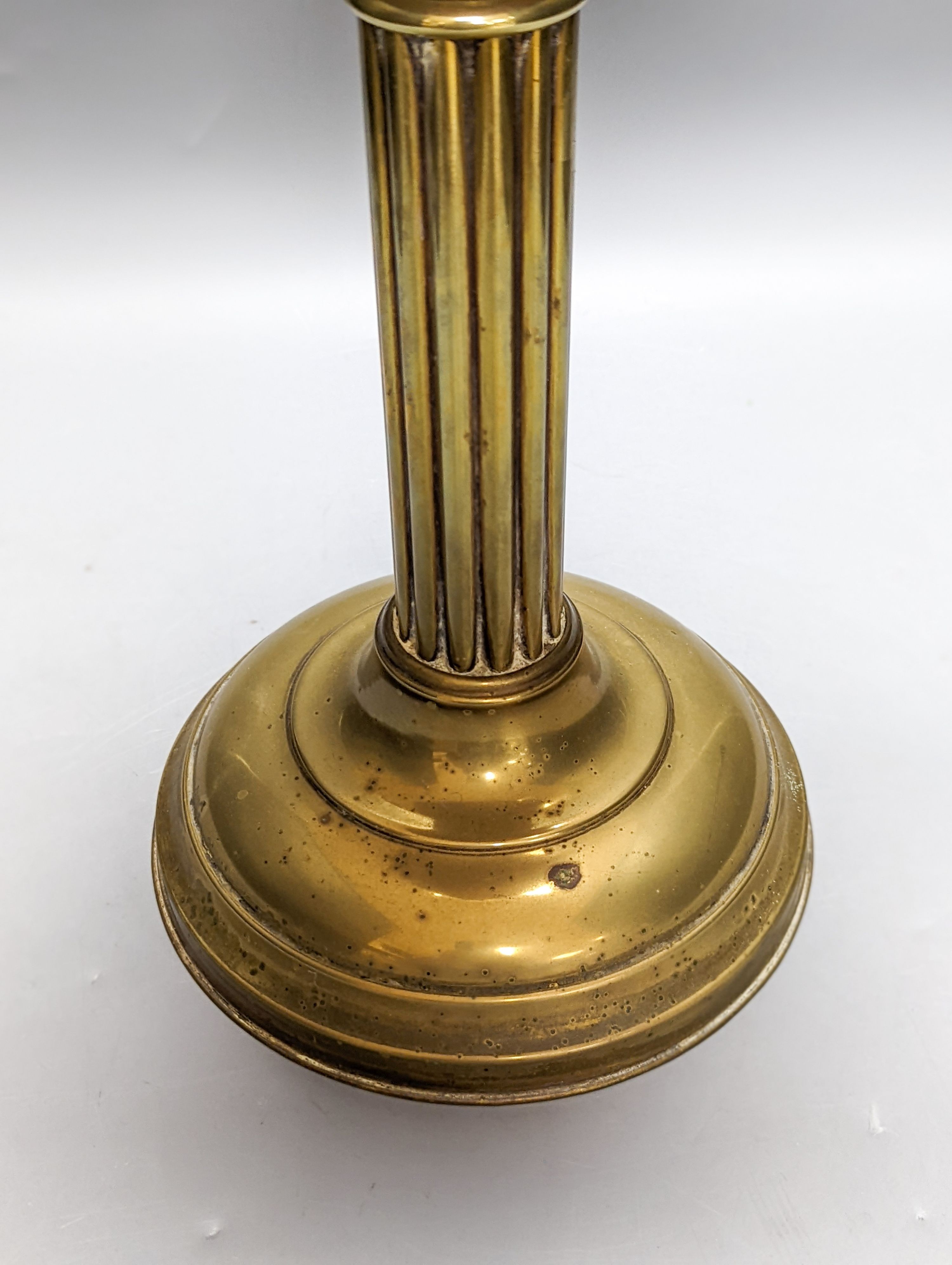 A Victorian brass oil lamp with etched glass shade and cranberry reservoir. 64cm total height